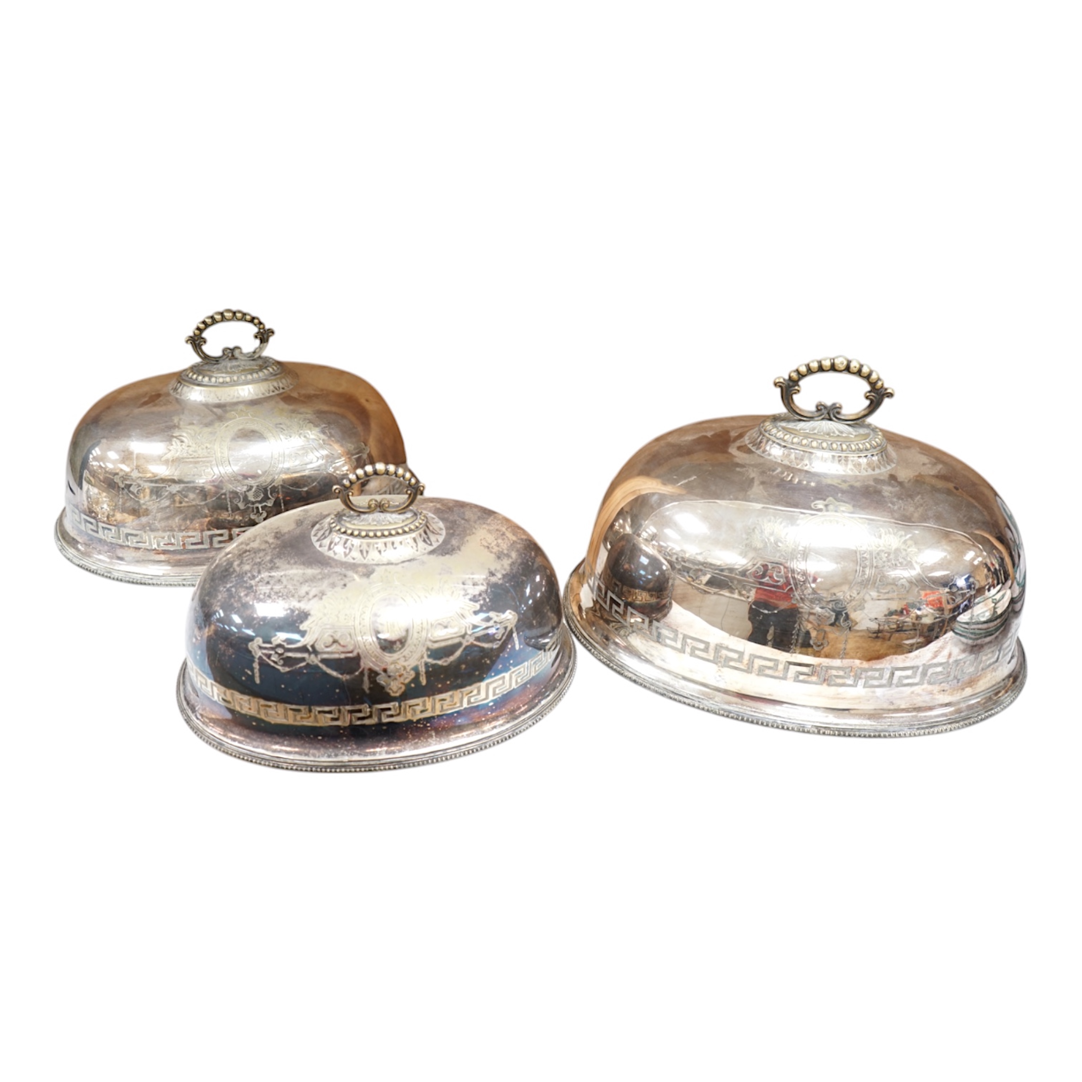 A set of three graduated Victorian silver plated meat dish covers, 51cm wide. Condition - plate in places worn